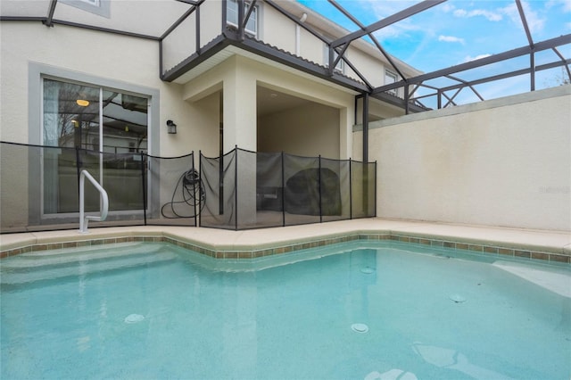 view of pool with glass enclosure