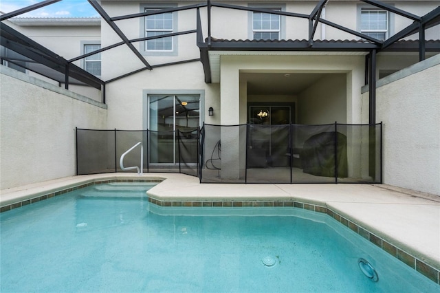 view of pool featuring glass enclosure