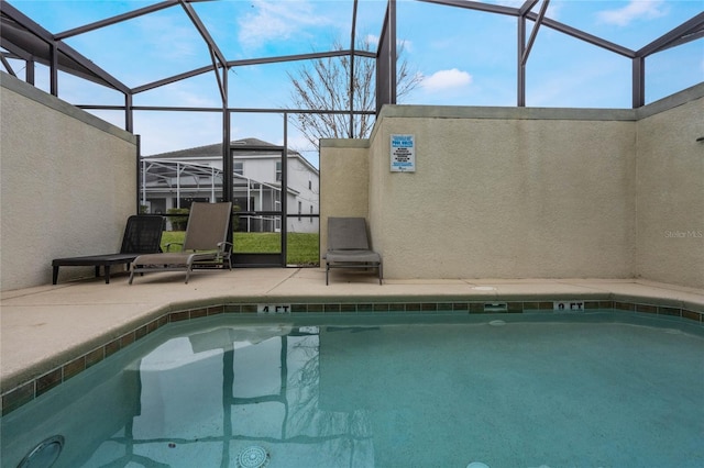 view of swimming pool with a patio and glass enclosure