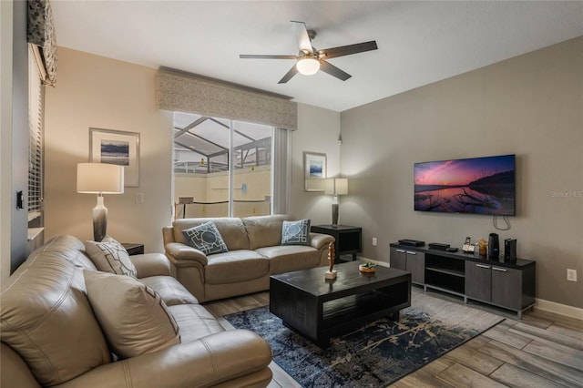 living room featuring ceiling fan and hardwood / wood-style floors