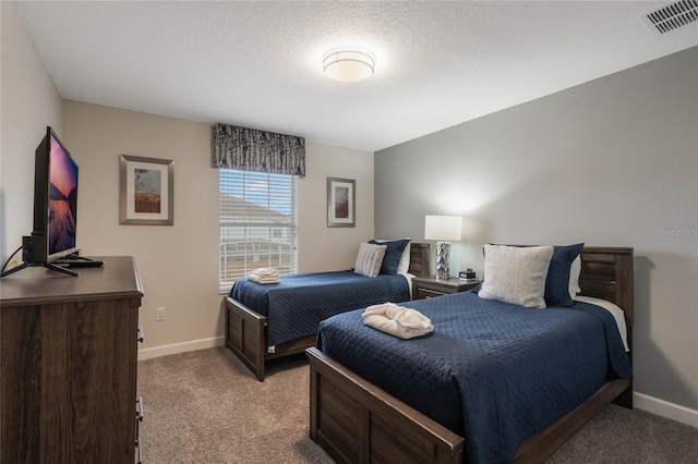 carpeted bedroom with a textured ceiling