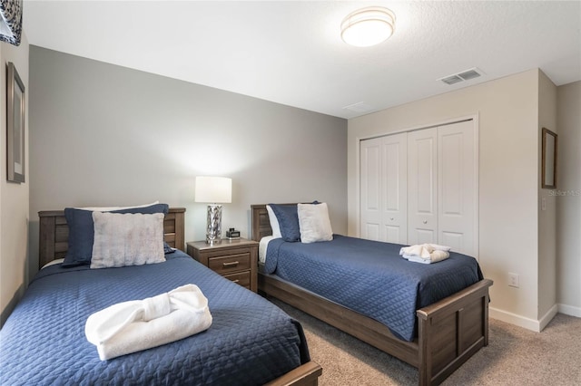 carpeted bedroom featuring a closet