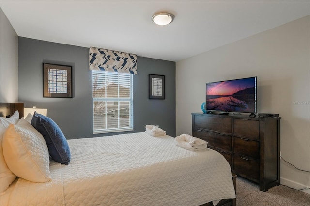 bedroom featuring light carpet