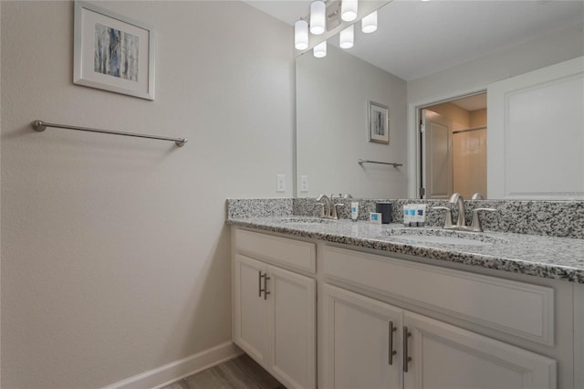 bathroom with vanity and a shower