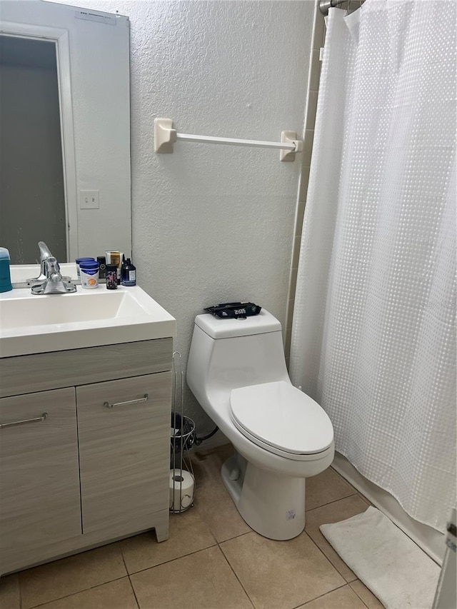 bathroom with vanity, tile patterned floors, toilet, and a shower with shower curtain