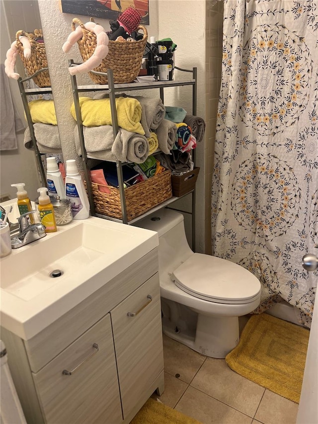 bathroom featuring tile patterned flooring, vanity, toilet, and a shower with shower curtain