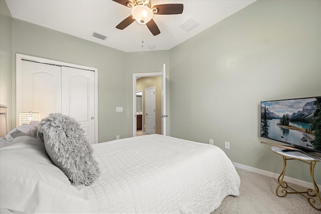 bedroom featuring light colored carpet, a closet, and ceiling fan