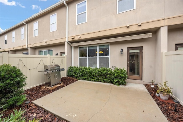 rear view of property featuring a patio area