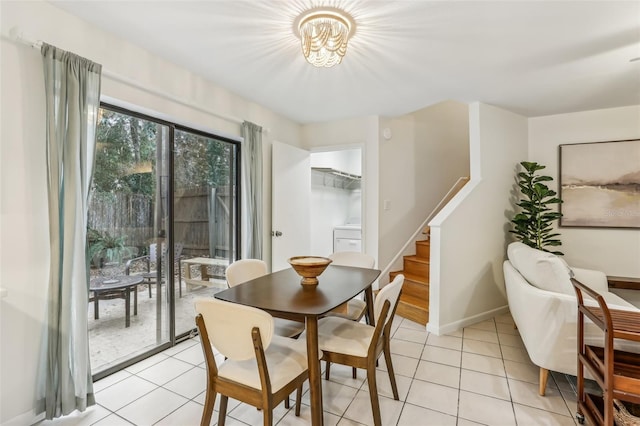 tiled dining space with washer / clothes dryer