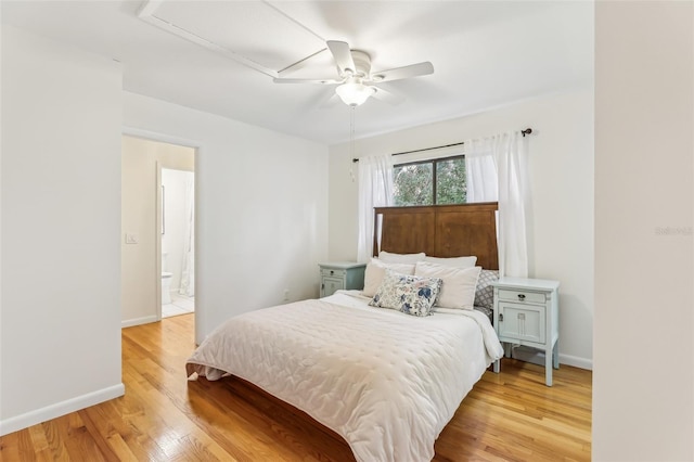 bedroom featuring ceiling fan, ensuite bathroom, and light hardwood / wood-style floors