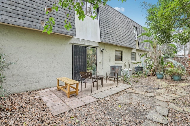 back of property featuring central AC unit and a patio area