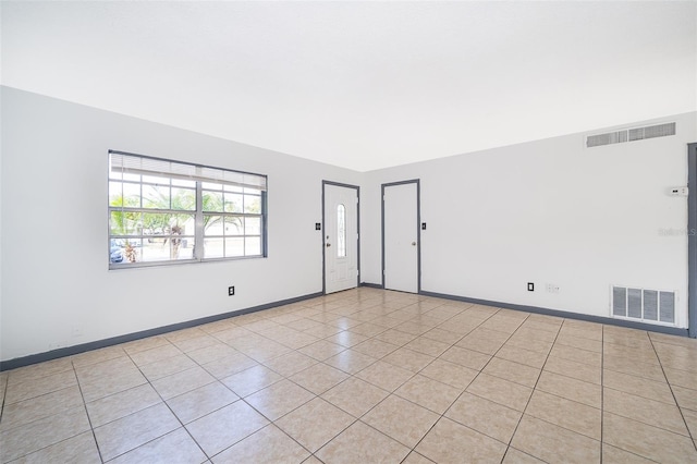 spare room featuring light tile patterned flooring