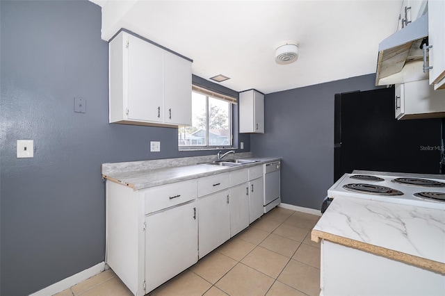 kitchen with white appliances, light tile patterned floors, sink, and white cabinets