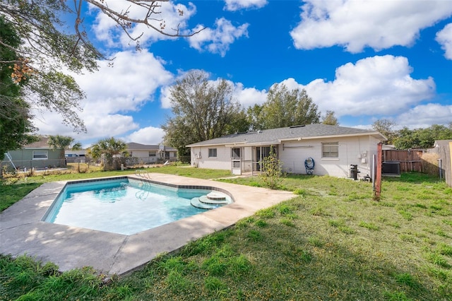 view of pool featuring cooling unit and a yard