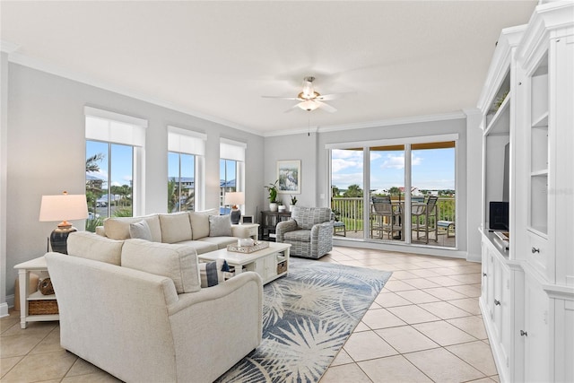 living room with ornamental molding, light tile patterned floors, and ceiling fan