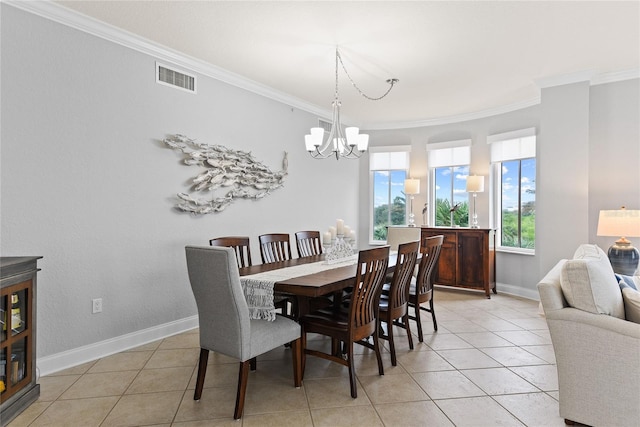 tiled dining space featuring crown molding and a chandelier