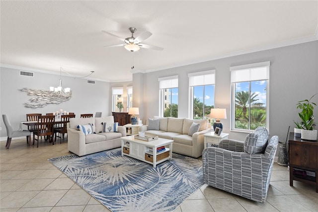 living room with ornamental molding, ceiling fan with notable chandelier, and light tile patterned floors