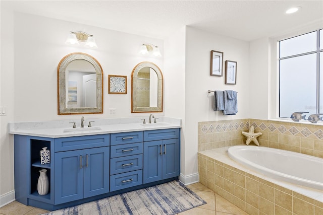 bathroom with vanity, tiled bath, and tile patterned flooring