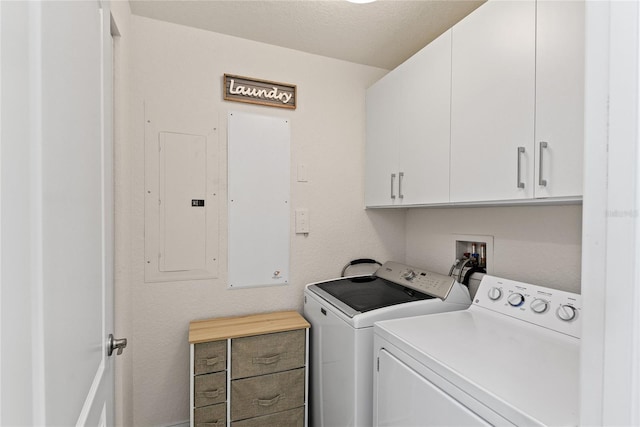 laundry room with cabinets, electric panel, and washing machine and dryer