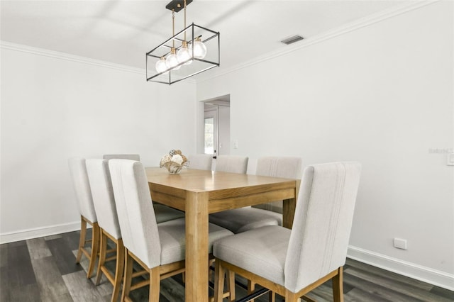 dining space with ornamental molding, dark wood-style flooring, visible vents, and baseboards