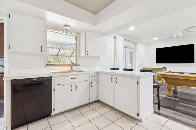 kitchen featuring black dishwasher, ceiling fan, light countertops, white cabinetry, and a sink