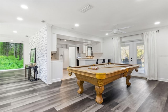 recreation room with french doors, light wood-type flooring, a sink, and visible vents