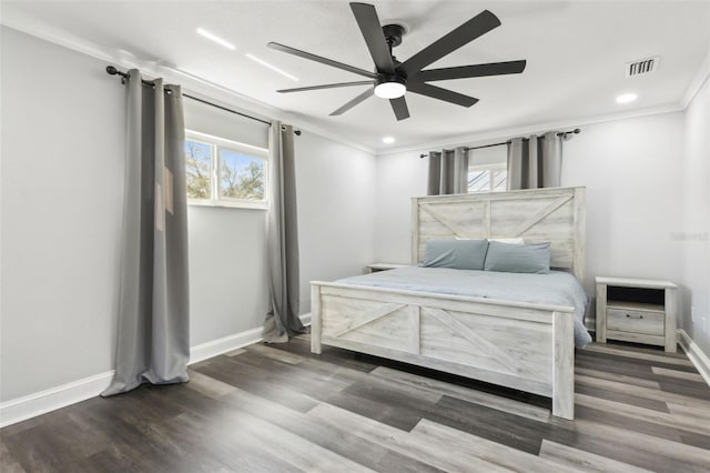 bedroom featuring wood finished floors, a ceiling fan, baseboards, visible vents, and crown molding