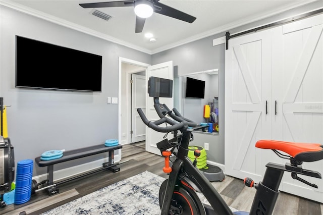 exercise room with ceiling fan, wood finished floors, visible vents, baseboards, and crown molding