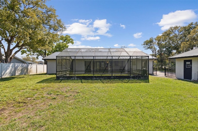 view of yard featuring a lanai and fence