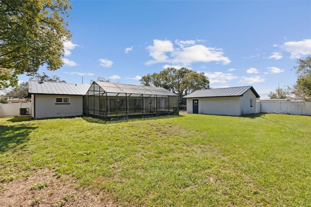 view of yard with a fenced backyard and a lanai