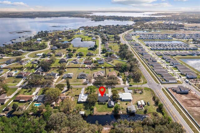 drone / aerial view featuring a residential view and a water view