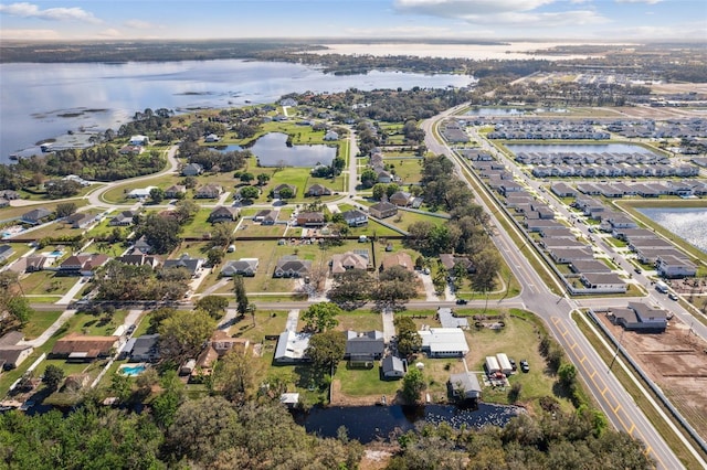 drone / aerial view with a water view and a residential view