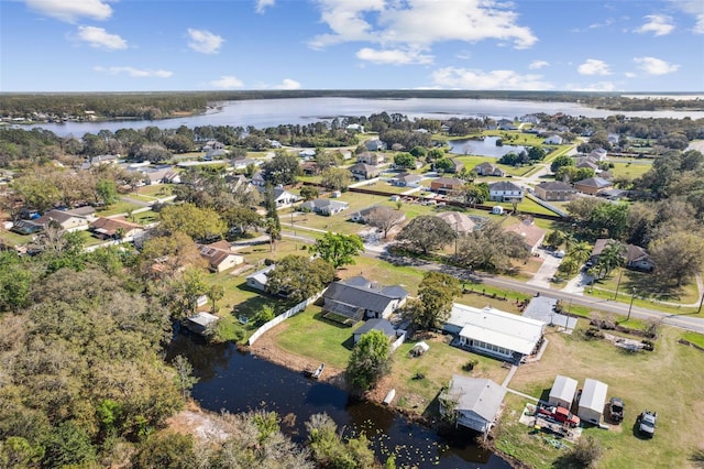 birds eye view of property with a water view and a residential view