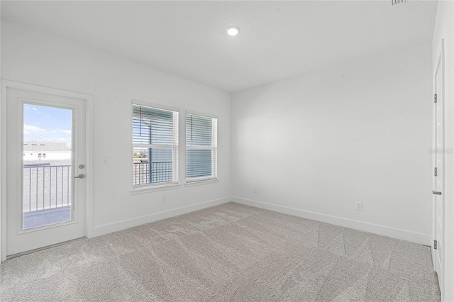 unfurnished room with light colored carpet