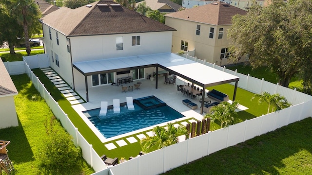 526 First Cape Coral Dr, Winter Garden, FL 34787 - rear view of property with a swimming pool with hot tub, a yard, an outdoor bar, and a patio area
