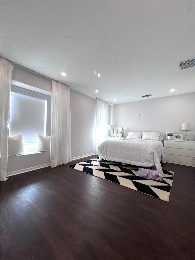 526 First Cape Coral Dr, Winter Garden, FL 34787 - bedroom with dark hardwood / wood-style flooring and a textured ceiling
