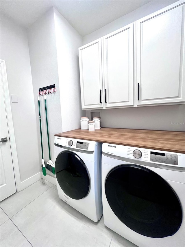 526 First Cape Coral Dr, Winter Garden, FL 34787 - laundry area with cabinets, separate washer and dryer, and light tile patterned floors