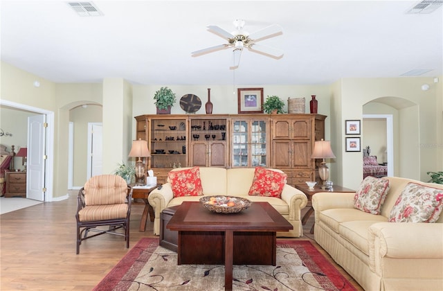 living room with ceiling fan and light hardwood / wood-style flooring