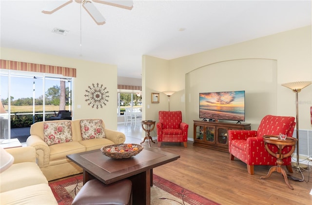 living room with ceiling fan and wood-type flooring