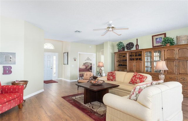 living room featuring ceiling fan and wood-type flooring