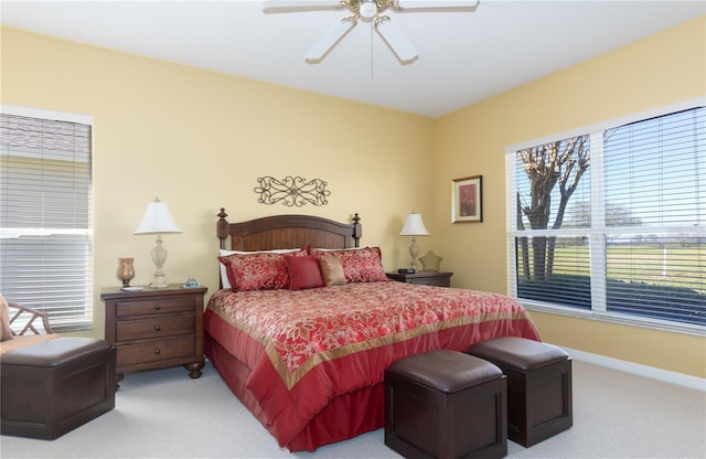 bedroom featuring ceiling fan and light carpet