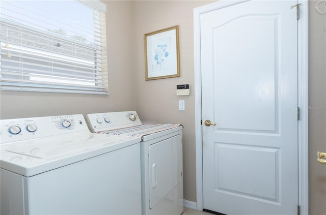 clothes washing area featuring independent washer and dryer