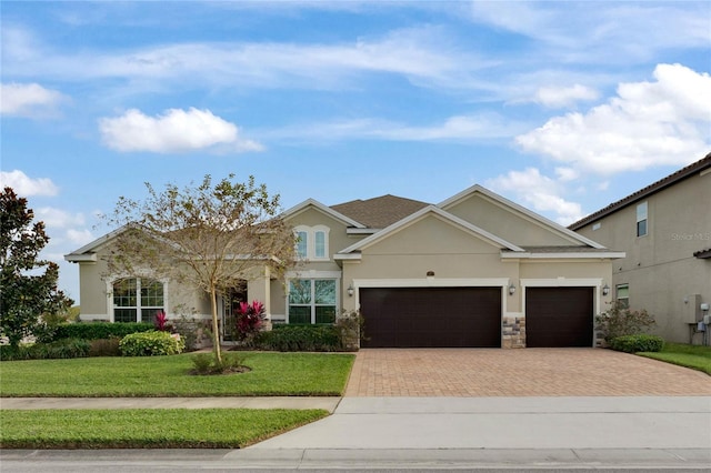 view of front of property featuring a garage and a front yard