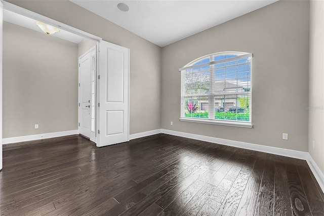 empty room featuring dark hardwood / wood-style flooring