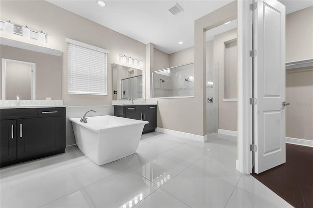 bathroom with tile patterned flooring, plus walk in shower, and vanity