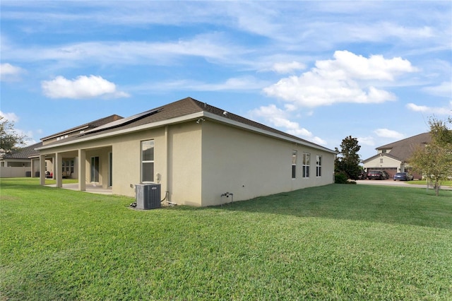 view of property exterior with cooling unit, a yard, and a patio