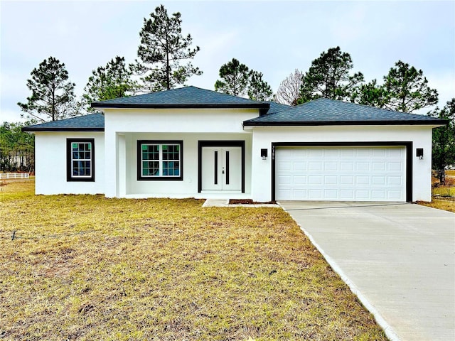 prairie-style home featuring a garage and a front yard