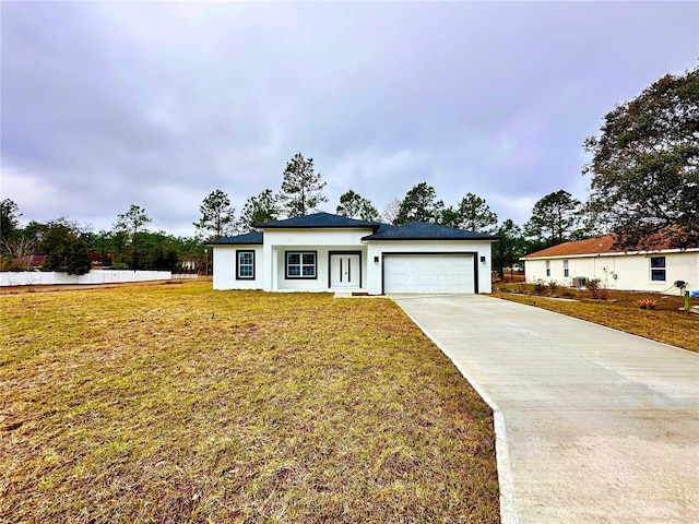 view of front of home with a garage and a front yard