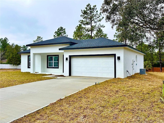 view of front facade featuring a garage, a front yard, and central air condition unit