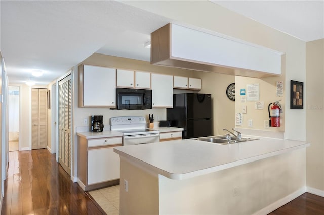 kitchen with sink, black appliances, light wood-type flooring, kitchen peninsula, and white cabinets